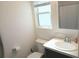 Bathroom featuring a single sink vanity, toilet, and a window providing natural light at 1974 Lockett Ln, The Villages, FL 34762