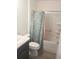 Clean bathroom showcasing a shower-tub combination with a leaf patterned curtain and a modern vanity at 1974 Lockett Ln, The Villages, FL 34762