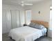 Comfortable bedroom featuring a queen-size bed, closet, and a window with blinds at 1974 Lockett Ln, The Villages, FL 34762