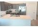 Well-equipped kitchen with stainless steel appliances, a breakfast bar, and sleek cabinets at 1974 Lockett Ln, The Villages, FL 34762