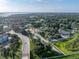 Expansive aerial view of the property showcasing its location near lush greenery and a serene lake at 222 Carpenters Way # 9, Lakeland, FL 33805