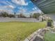 A large backyard with tall privacy wall and grass at 222 Carpenters Way # 9, Lakeland, FL 33805