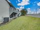 A large yard behind the condos with a high privacy wall and lawn at 222 Carpenters Way # 9, Lakeland, FL 33805