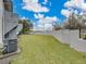 A large yard behind the condos with a high privacy wall and lawn at 222 Carpenters Way # 9, Lakeland, FL 33805