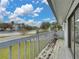View from balcony overlooking the street with railings and sliding glass doors at 222 Carpenters Way # 9, Lakeland, FL 33805