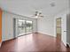 Bedroom with hardwood floors, sliding glass doors to a balcony, and white walls at 222 Carpenters Way # 9, Lakeland, FL 33805