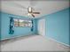 Bright bedroom featuring light blue walls, carpet, a ceiling fan, and a window at 222 Carpenters Way # 9, Lakeland, FL 33805