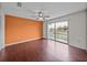 Spacious bedroom with hardwood floors, a ceiling fan, and sliding glass doors to a balcony at 222 Carpenters Way # 9, Lakeland, FL 33805