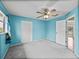 Bright bedroom with a ceiling fan, closet, and an open door to the rest of the house at 222 Carpenters Way # 9, Lakeland, FL 33805