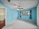 Bedroom with light blue walls, a ceiling fan, carpet, and a view of the hallway at 222 Carpenters Way # 9, Lakeland, FL 33805