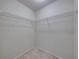 Walk-in closet featuring wire shelving and neutral carpeting providing ample storage space at 222 Carpenters Way # 9, Lakeland, FL 33805