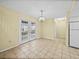 Bright dining area with French doors and tile flooring, adjacent to the kitchen, perfect for entertaining at 222 Carpenters Way # 9, Lakeland, FL 33805
