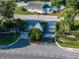 Community entrance with mature landscaping, decorative gate and security pavilion at 222 Carpenters Way # 9, Lakeland, FL 33805