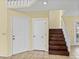 Bright entryway with tile flooring, staircase, and white doors creating a welcoming and functional space at 222 Carpenters Way # 9, Lakeland, FL 33805