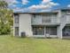 A two-story condo featuring a balcony, screened in patio, and lawn at 222 Carpenters Way # 9, Lakeland, FL 33805