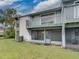 Exterior view of home with balcony, screened-in porch, and grass lawn at 222 Carpenters Way # 9, Lakeland, FL 33805