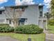 Charming townhouse features a well-maintained lawn and beautiful shrubbery enhancing its curb appeal at 222 Carpenters Way # 9, Lakeland, FL 33805