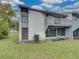 A two-story condo featuring a balcony, screened in patio, and lawn at 222 Carpenters Way # 9, Lakeland, FL 33805
