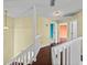 Hallway with wooden floor and multiple doorways leading to different rooms at 222 Carpenters Way # 9, Lakeland, FL 33805