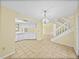 Open kitchen with white appliances and tile flooring adjacent to the stairwell at 222 Carpenters Way # 9, Lakeland, FL 33805