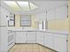 Bright kitchen with white appliances, countertops, cabinets and skylight providing natural light at 222 Carpenters Way # 9, Lakeland, FL 33805