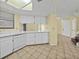 Bright kitchen with white appliances, countertops, cabinets and tile flooring at 222 Carpenters Way # 9, Lakeland, FL 33805