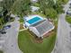Aerial view of a community pool surrounded by landscaping near a building with a gray roof at 222 Carpenters Way # 9, Lakeland, FL 33805