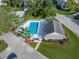 Aerial view shows a rectangular pool with ample lounge space, surrounded by lush landscaping near building at 222 Carpenters Way # 9, Lakeland, FL 33805