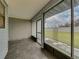 View of tiled screened-in porch with large window and view of the exterior at 222 Carpenters Way # 9, Lakeland, FL 33805
