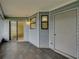 Tiled porch with gray siding and exterior door at 222 Carpenters Way # 9, Lakeland, FL 33805