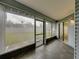 Tiled porch with exterior view through screened windows at 222 Carpenters Way # 9, Lakeland, FL 33805