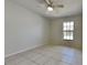Bedroom features neutral paint, tile flooring, and natural lighting at 512 Lost Creek Ct, Kissimmee, FL 34743