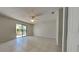 Neutral bedroom featuring tile flooring and access to the lanai at 512 Lost Creek Ct, Kissimmee, FL 34743