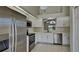Modern kitchen with stainless steel appliances, white cabinets, and tile flooring at 512 Lost Creek Ct, Kissimmee, FL 34743