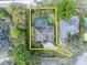 Aerial view of a home with a screened-in pool and well-maintained backyard near a lush lake at 5406 Baytowne Place, Oviedo, FL 32765