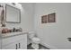 A well-lit half bathroom with a stylish vanity, modern fixtures, and decor at 5406 Baytowne Place, Oviedo, FL 32765