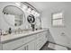 Elegant bathroom featuring double sinks, vanity with marble countertop, and stylish lighting at 5406 Baytowne Place, Oviedo, FL 32765