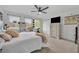 A spacious bedroom features a king bed, white furniture, a ceiling fan, and three large windows at 5406 Baytowne Place, Oviedo, FL 32765