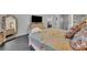 The bedroom features an earth toned floral comforter, large dresser with TV, and a decorative framed mirror at 5406 Baytowne Place, Oviedo, FL 32765
