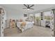 This neutral toned bedroom features a king bed, white furniture, a ceiling fan, and three windows at 5406 Baytowne Place, Oviedo, FL 32765