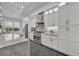 The gourmet kitchen has stainless steel appliances, white cabinetry, stone backsplash and countertops at 5406 Baytowne Place, Oviedo, FL 32765