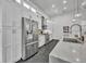 Modern kitchen showcasing stainless steel appliances, custom cabinetry, and sleek countertops at 5406 Baytowne Place, Oviedo, FL 32765