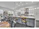 Bright kitchen featuring an oversized kitchen island with seating, stylish pendant lights, and stainless appliances at 5406 Baytowne Place, Oviedo, FL 32765