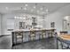 Modern kitchen featuring a large center island with seating, pendant lighting, and stainless steel appliances at 5406 Baytowne Place, Oviedo, FL 32765