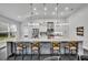 Kitchen featuring an oversized kitchen island with seating, stylish pendant lights, and stainless appliances at 5406 Baytowne Place, Oviedo, FL 32765