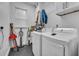 Bright laundry room with modern appliances, storage, and natural light at 5406 Baytowne Place, Oviedo, FL 32765
