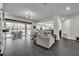 Bright living room with access to the outdoor pool area and an open connection to the kitchen at 5406 Baytowne Place, Oviedo, FL 32765