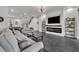 Bright and spacious living room with modern decor, open layout, and sleek tile flooring at 5406 Baytowne Place, Oviedo, FL 32765