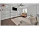 Comfortable living room with large windows, ceiling fan, built-in shelves, and stylish furnishings at 5406 Baytowne Place, Oviedo, FL 32765