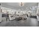 Open-concept living area featuring tile floors, modern furnishings, and seamless flow to the kitchen at 5406 Baytowne Place, Oviedo, FL 32765